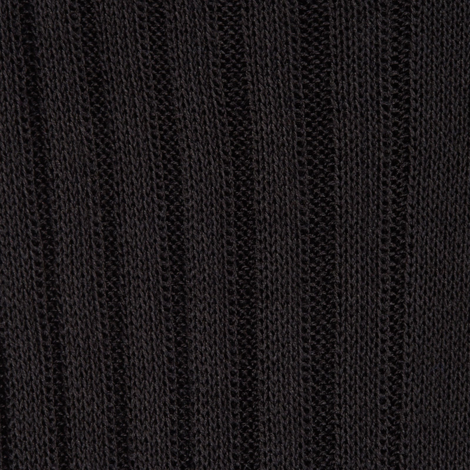 Image 2 of product A single Charcoal Long Cotton Sock by Turnbull & Asser, in black Egyptian cotton, is shown against a plain white background at an angle with the foot pointing downward and the leg extending upward.