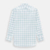 View 3 of product The Turnbull & Asser Sage Grid Check Mayfair Shirt is a white, long-sleeve shirt made from Italian cotton with a light blue and sage grid pattern, shown neatly laid flat on a plain, light background.