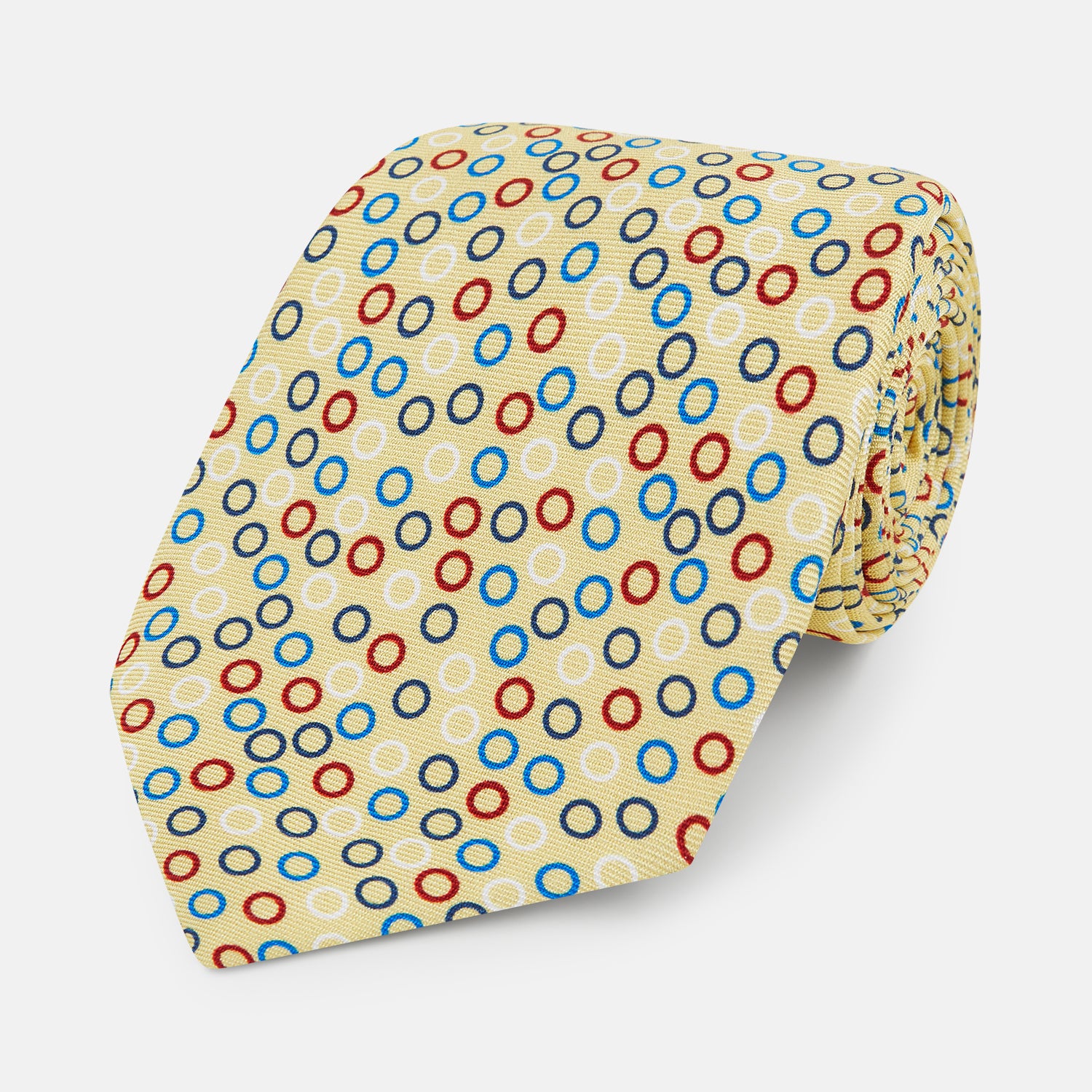 View 1 of product The Turnbull & Asser Multi-coloured Circle Yellow Printed Silk Tie features vibrant blue, red, and black circles evenly spaced across luxurious English silk.