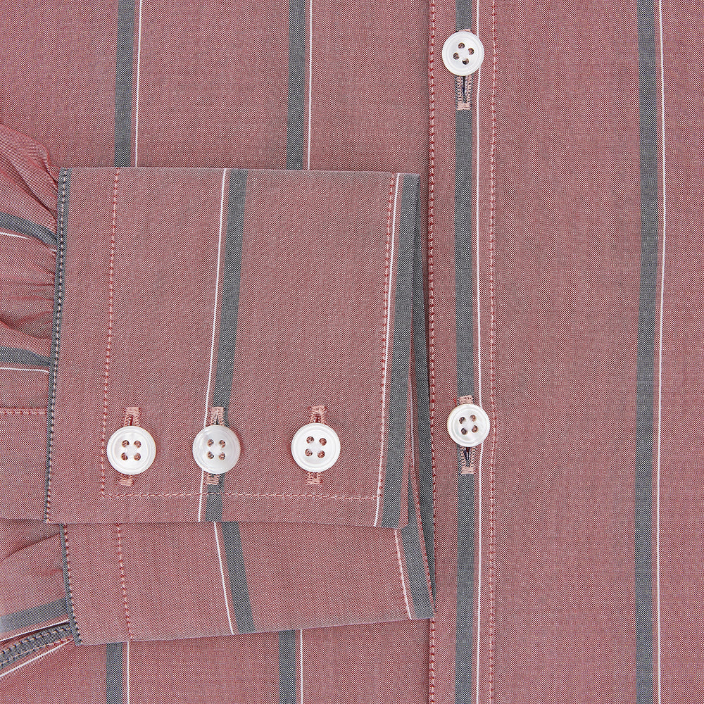 The Turnbull & Asser Red Track Stripe Westminster Shirt features British craftsmanship, a collar, pink base with vertical blue and white stripes, white buttons, and a pocket-free front for refined appeal.