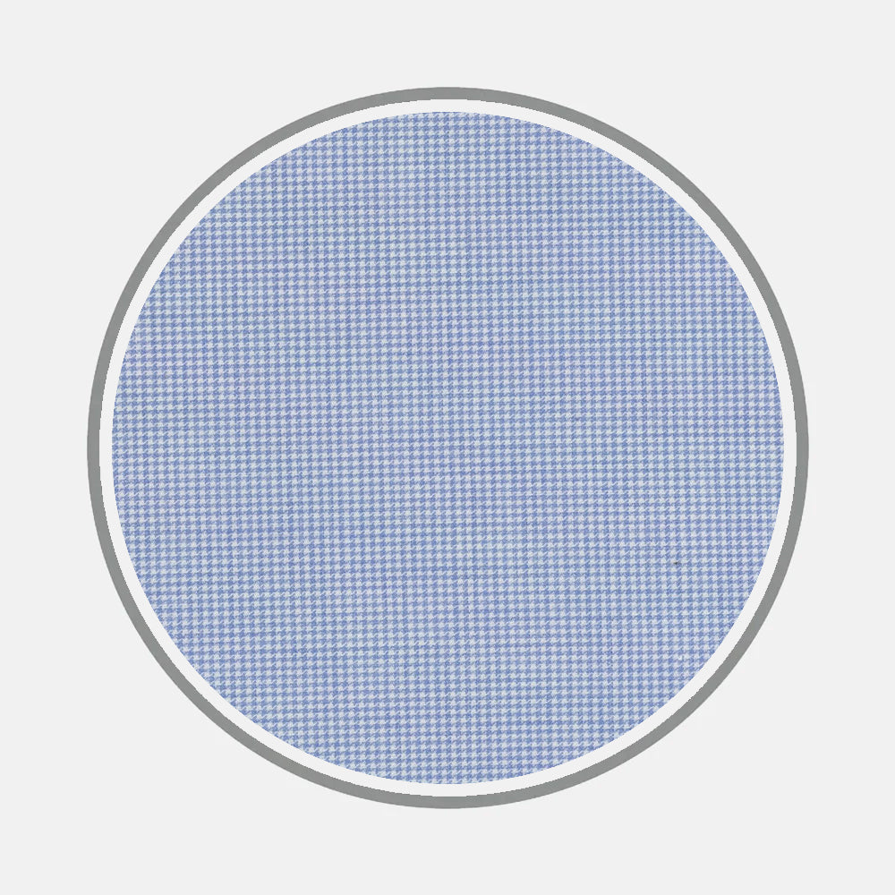 A circular swatch of Bespoke Fabric 0124 32 by Turnbull & Asser, featuring a blue and white small houndstooth pattern with a thin gray border on light gray—ideal for custom shirts or monogram style selection.