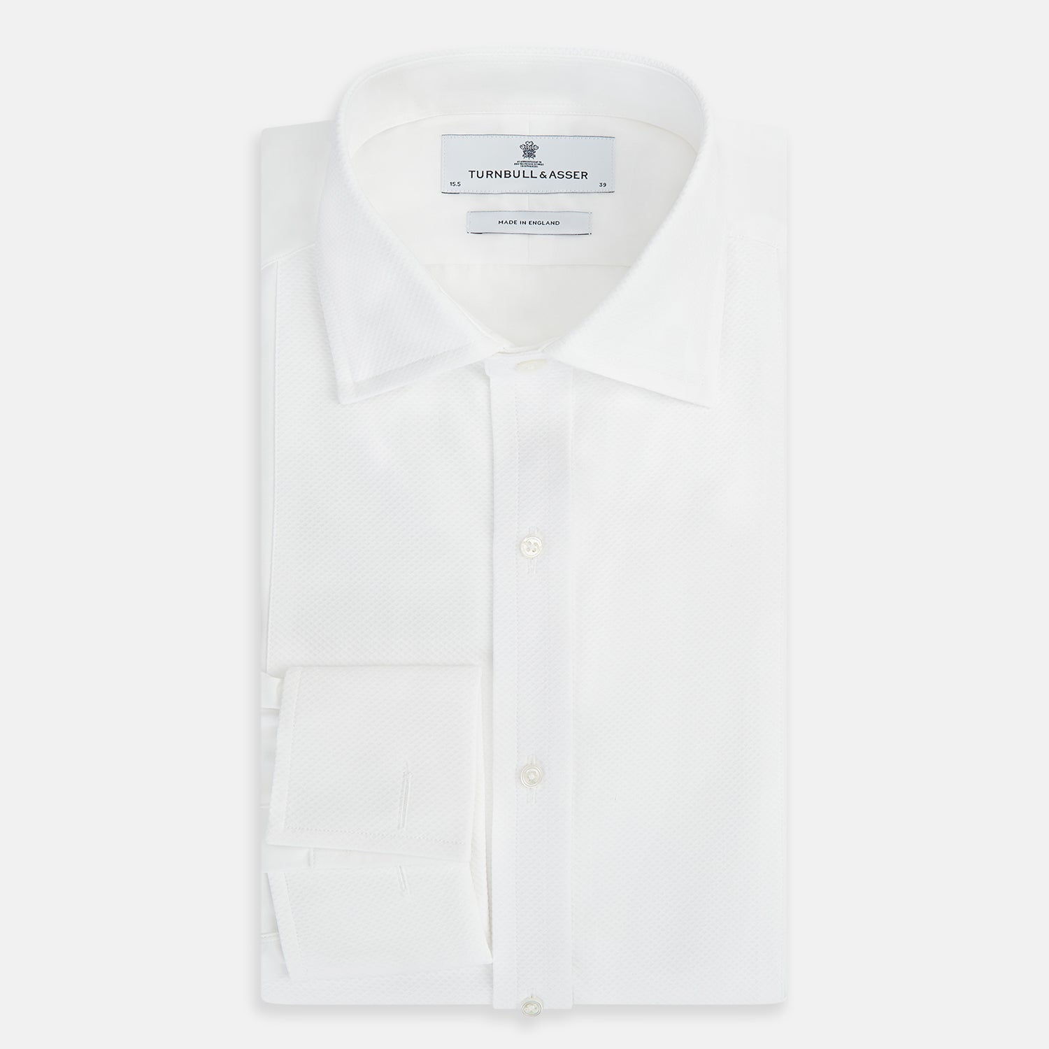 View 5 of product The Turnbull & Asser Tailored Fit White Marcella Front Shirt features a Kent Collar and double cuffs, shown laid flat on a white background. Perfect as a black tie shirt for formal events.