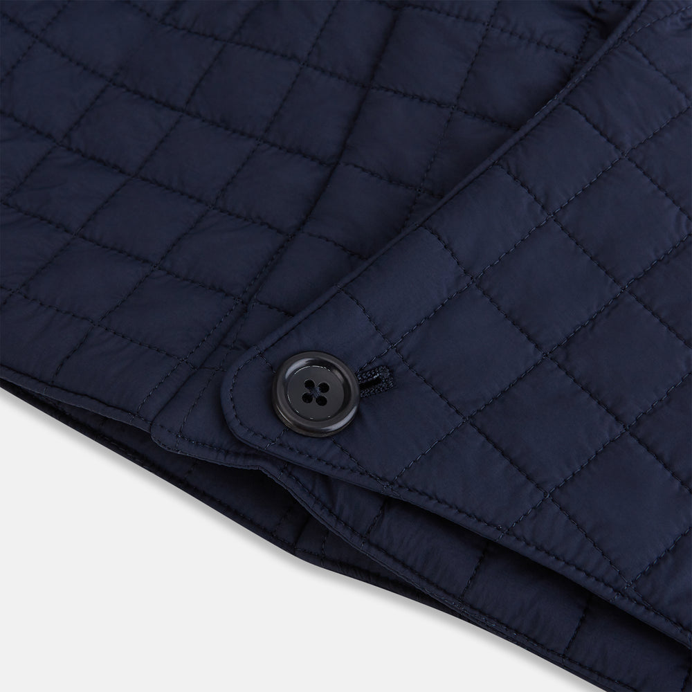 The Turnbull & Asser Navy Quilted Hood with Neck Warmer features diamond pattern stitching, a structured hood, overlapping collar, and button closure, shown on a plain white background.