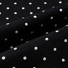 View 3 of product The Turnbull & Asser Black and White Spotted Silk Scarf with Fringes features a classic polka dot design, silver fringe edges, and the brand name printed near each end.