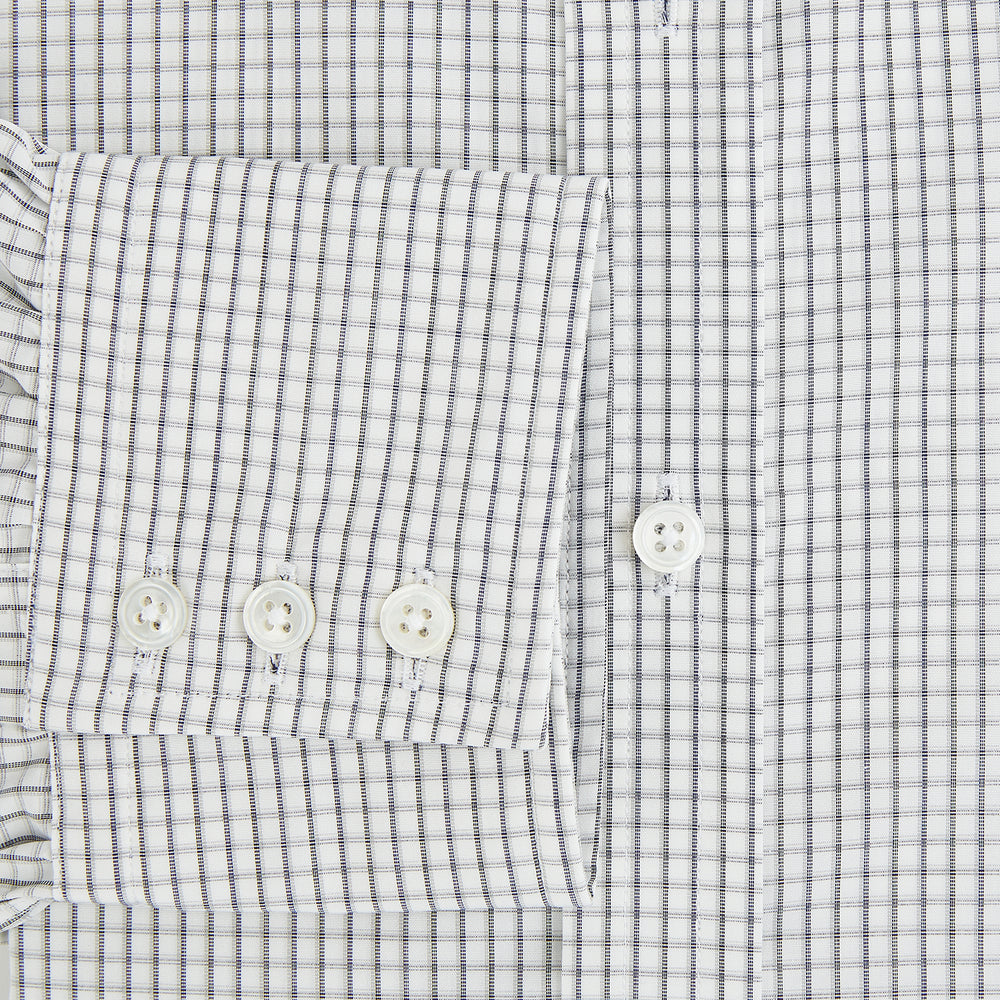 The Midnight Blue Multi Check Mayfair Shirt by Turnbull & Asser is a pure cotton, long-sleeve button-down featuring a small blue multi-check pattern, pointed collar, and buttoned cuffs.