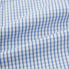 View 6 of product The Sky Blue Micro Shadow Check Mayfair Shirt by Turnbull & Asser features long sleeves, a classic collar, buttoned cuffs, and a light blue and white micro check pattern—showcasing refined British craftsmanship.