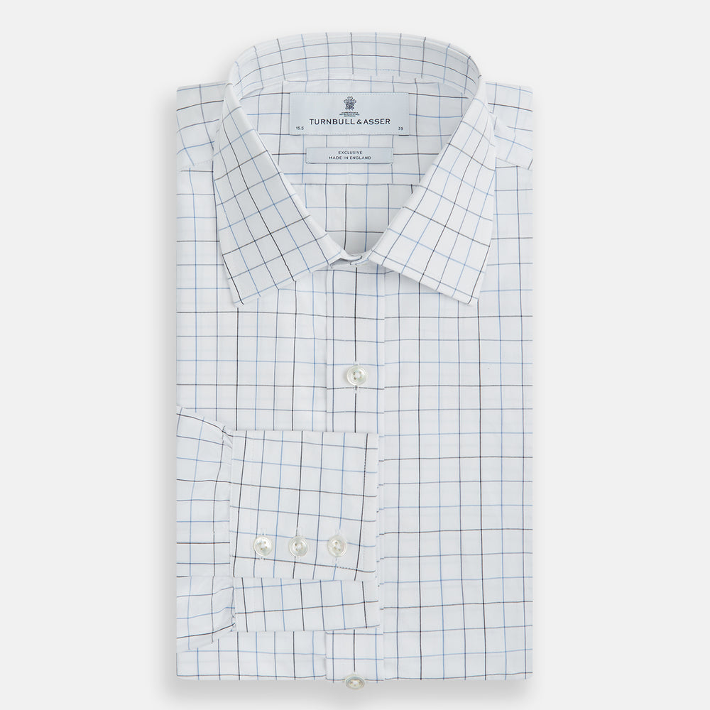 The Blue Grid Check Mayfair Shirt by Turnbull & Asser is a long-sleeve, button-up shirt with a T&A collar, crafted from organic cotton in a light and dark blue grid pattern, shown flat against a white background.