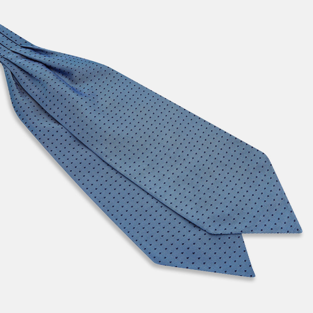 The Turnbull & Asser Navy and Blue Micro Dot Silk Cravat, featuring a refined dot pattern, makes an elegant statement when paired with a matching pocket square, showcased here against a white background.