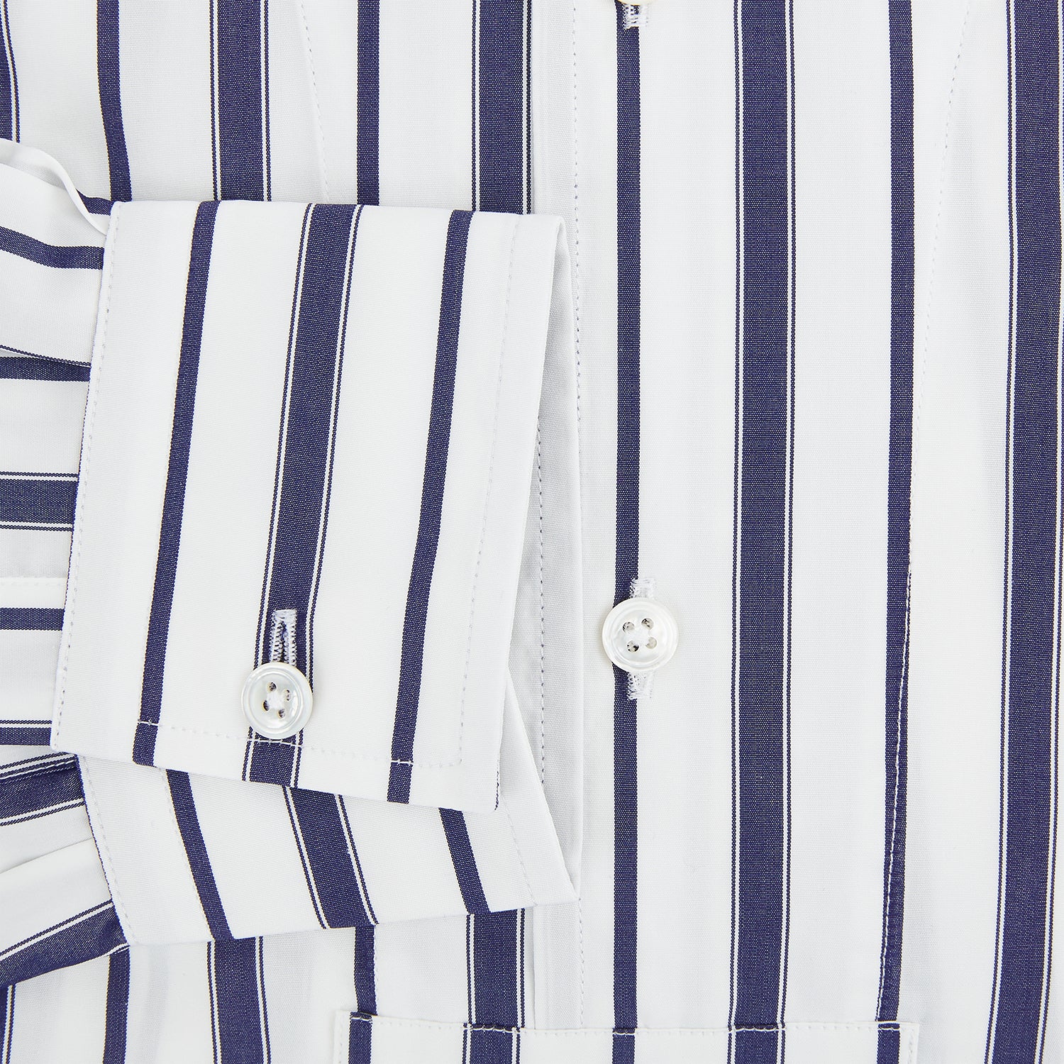 View 4 of product The Turnbull & Asser Navy Double Stripe Quarzo Nightshirt, a knee-length Italian cotton nightshirt with navy and white vertical stripes, collar, chest pocket, and button-down front, is displayed flat on a white background.