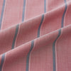View 8 of product The Turnbull & Asser Red Track Stripe Westminster Shirt features British craftsmanship, a collar, pink base with vertical blue and white stripes, white buttons, and a pocket-free front for refined appeal.