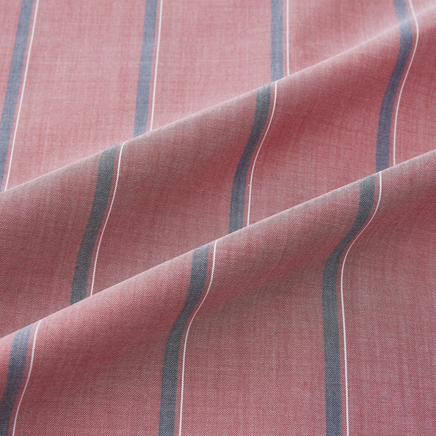 View 8 of product The Turnbull & Asser Red Track Stripe Westminster Shirt features British craftsmanship, a collar, pink base with vertical blue and white stripes, white buttons, and a pocket-free front for refined appeal.