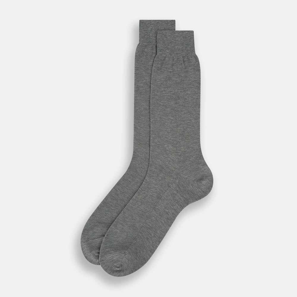 A single Steel Melange Micro Knit Mid-Length Sock by Turnbull & Asser, knee-high and gray, crafted from mercerised Egyptian cotton with a subtle micro knit pattern, is displayed upright on a plain white background.