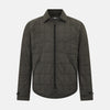 View 1 of product The Battersea Shadow Grey Quilted Jacket by Turnbull & Asser features a front zipper, buttoned cuffs, pointed collar, and multiple pockets—an ideal choice for the modern gentleman. Shown on a plain white background.