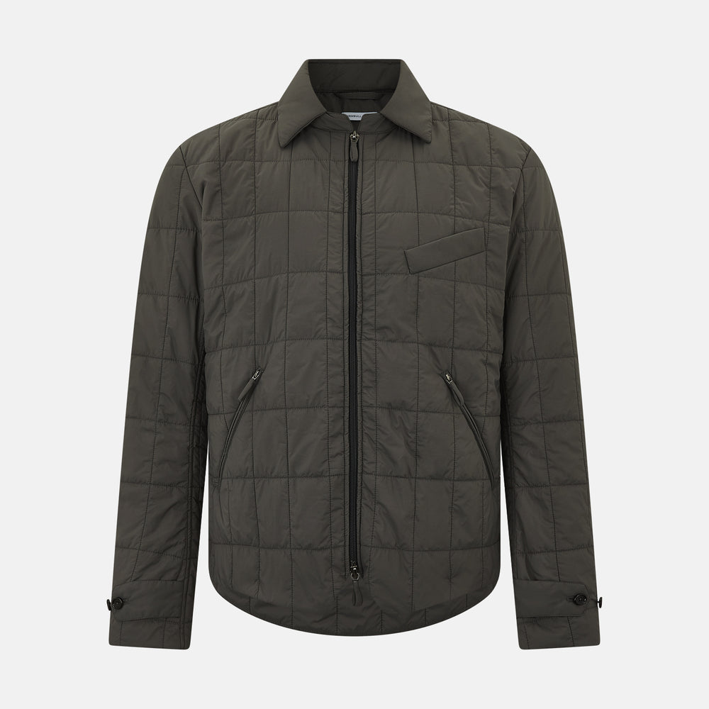 The Battersea Shadow Grey Quilted Jacket by Turnbull & Asser features a front zipper, buttoned cuffs, pointed collar, and multiple pockets—an ideal choice for the modern gentleman. Shown on a plain white background.