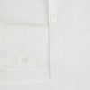 View 4 of product The Turnbull & Asser Plain White Windsor Shirt features a Turnbull open collar, 3-button cuffs, and relaxed fit—exemplifying British craftsmanship. Displayed on a white background.
