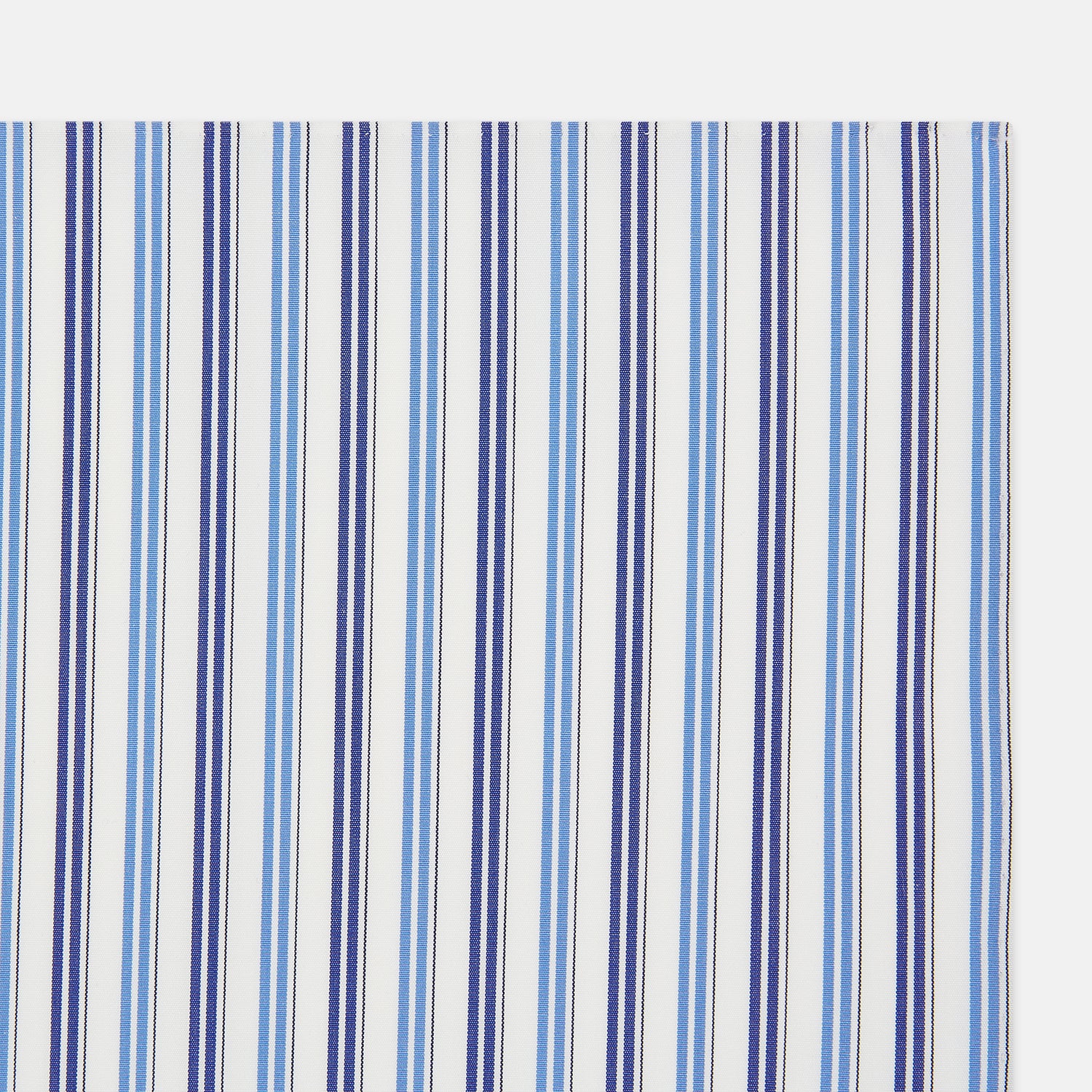 Image 2 of product The Blue and Navy Multi Stripe Hand-Rolled Handkerchief by Turnbull & Asser is crafted in England with a white background and evenly spaced vertical stripes in blue and navy.