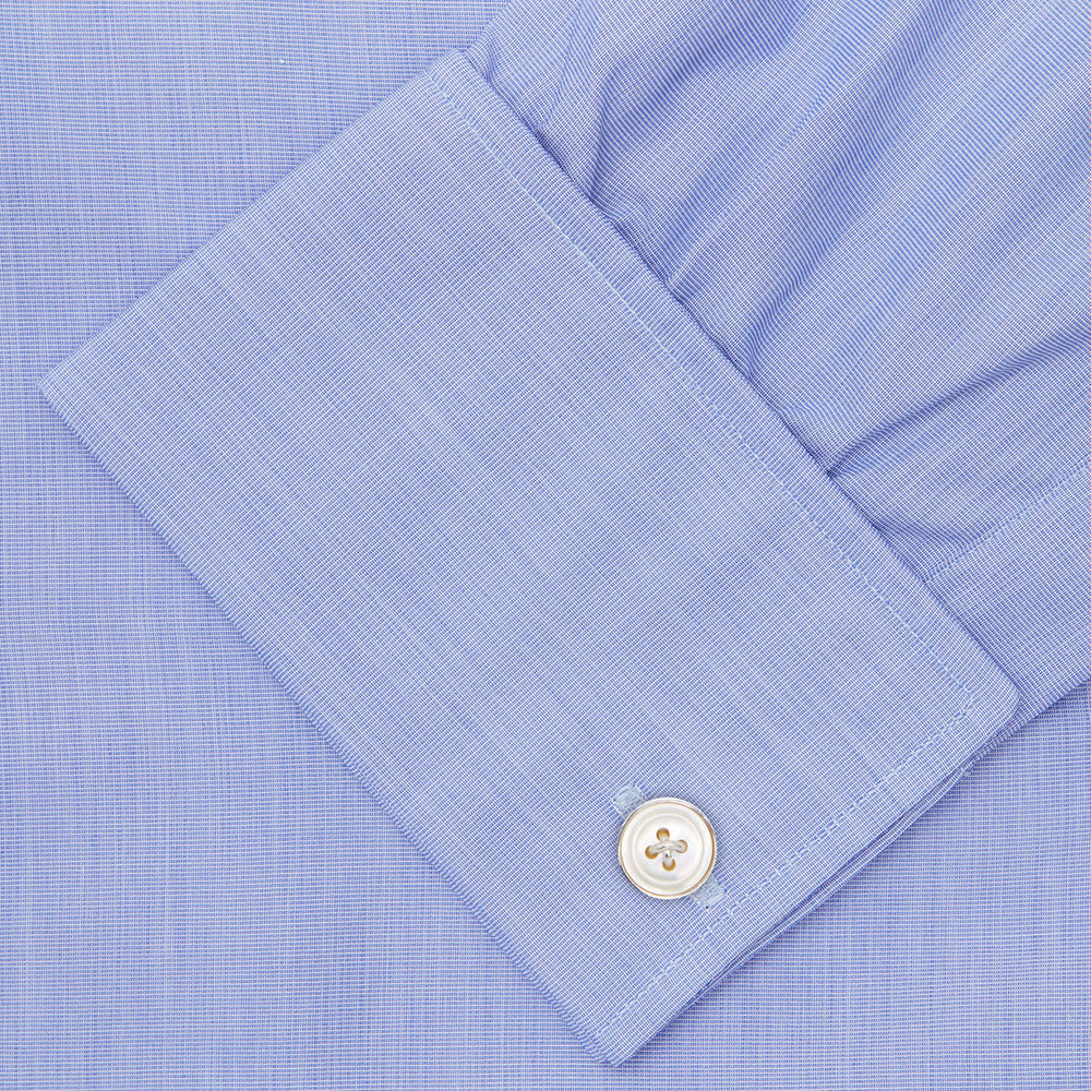 The Turnbull & Asser Blue End-on-End Cotton Shirt features a T&A collar, double cuffs, and white buttons—ideal for smart looks or pairing with a navy suit. Displayed against a plain white background.