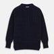 The Turnbull & Asser Navy Wool and Cotton Blend Albany Guernsey Jumper, shown flat on a white background, features long sleeves, a classic cable knit pattern on the upper half, and ribbed cuffs, hem, and collar.