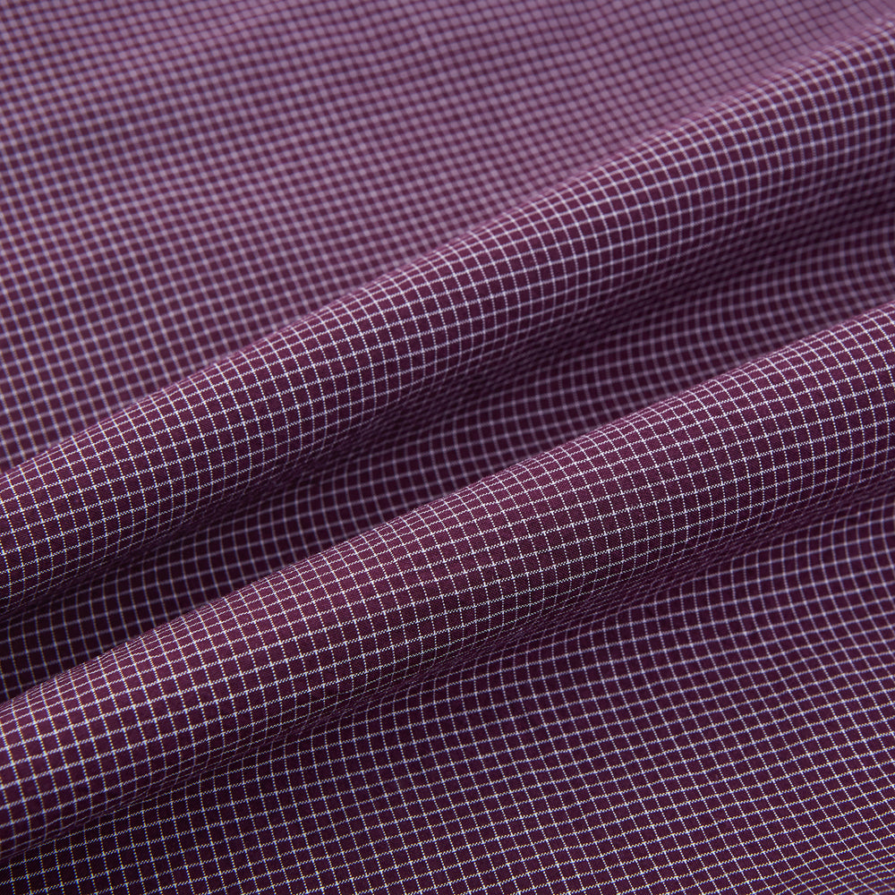 The Turnbull & Asser Burgundy Pin Check Padded Gilet features a front zipper, two zippered side pockets, a chest pocket, and a rounded hem—an ideal men’s layering piece shown on a white background.