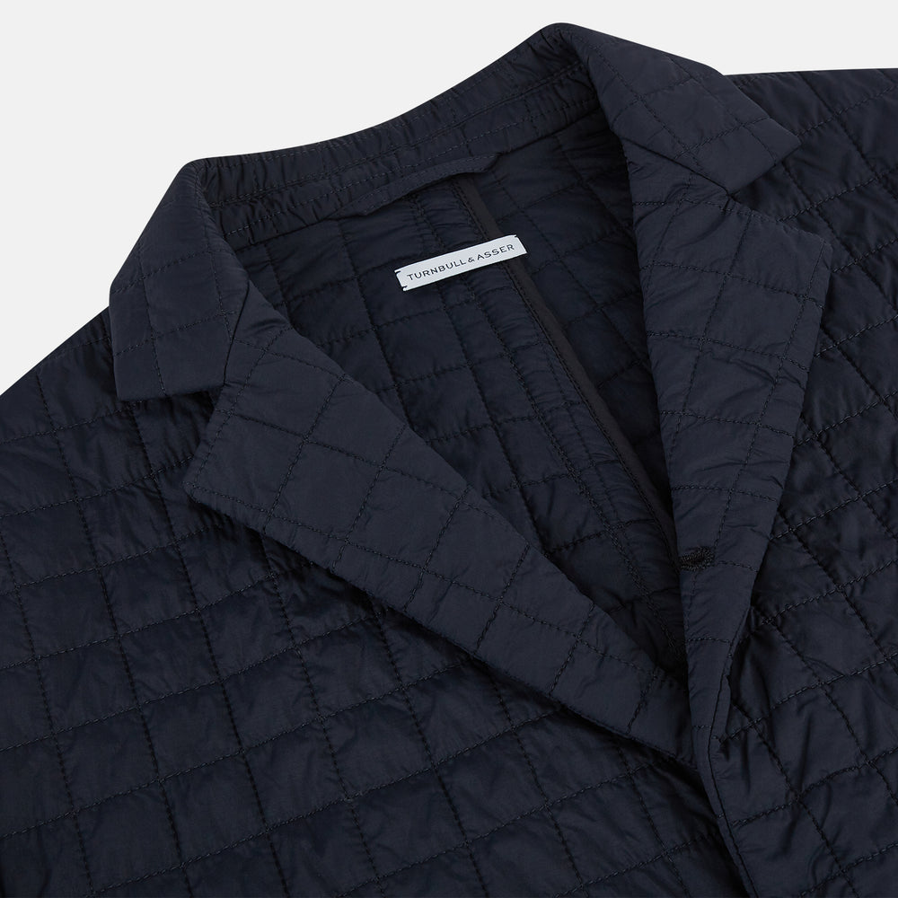 The Fulham Navy Single-Breasted Quilted Blazer by Turnbull & Asser features a notched lapel, three black buttons, a chest pocket, and two front flap pockets. Shown on a plain white background—ideal for the modern gentleman.