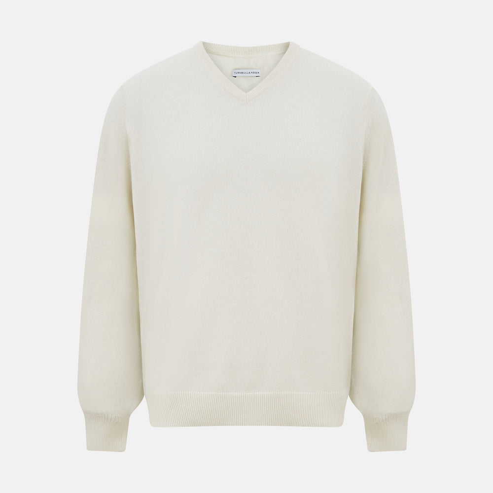 The Turnbull & Asser White Cashmere V-Neck Jumper features long sleeves and a versatile light cream shade, making it a timeless addition to your knitwear collection.