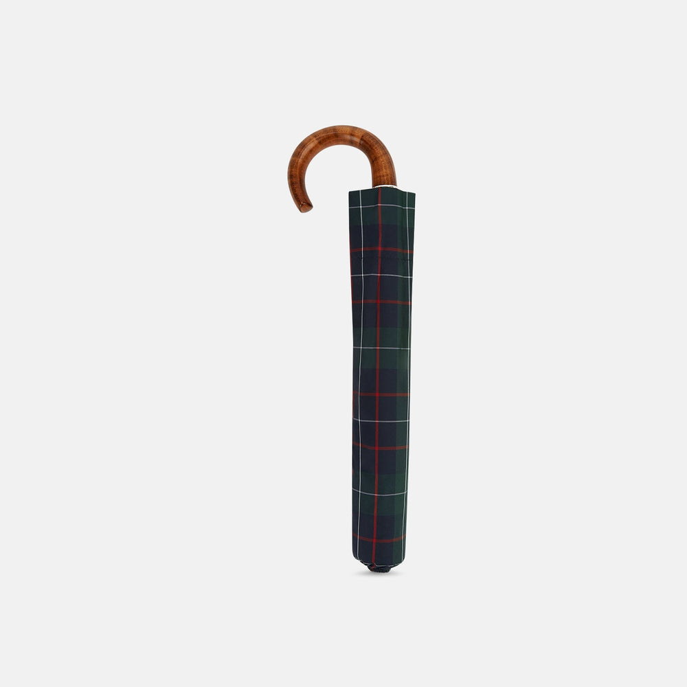 The Turnbull & Asser Colquhoun Tartan Telescopic Umbrella features a green, blue, and red plaid canopy, a durable metal shaft, and a brown maple crook handle, displayed against a plain light background.