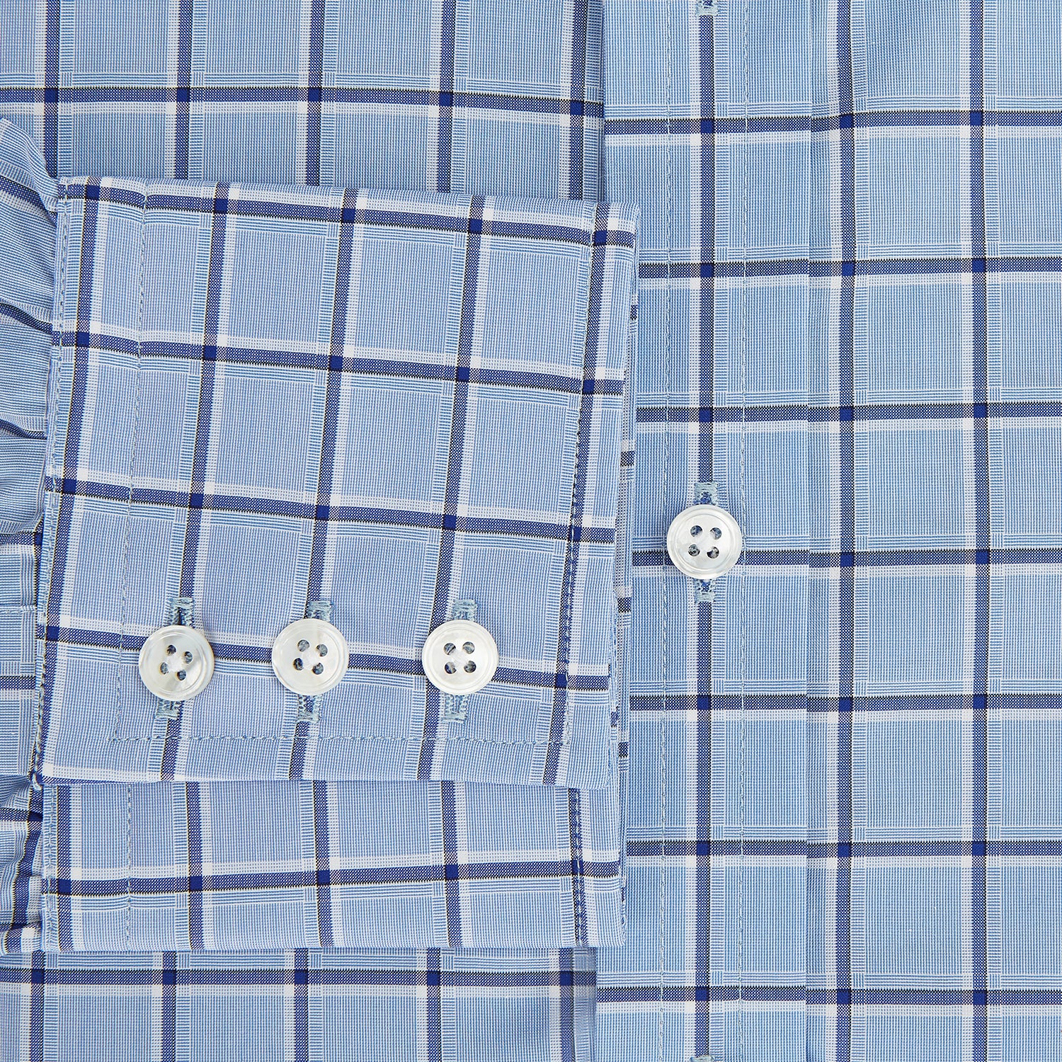 Image 4 of product The Turnbull & Asser Blue and Navy Windowpane Mayfair Shirt features long sleeves, a T&A collar, buttoned cuffs, and Italian cotton in a blue and navy windowpane pattern, shown on a plain white background.
