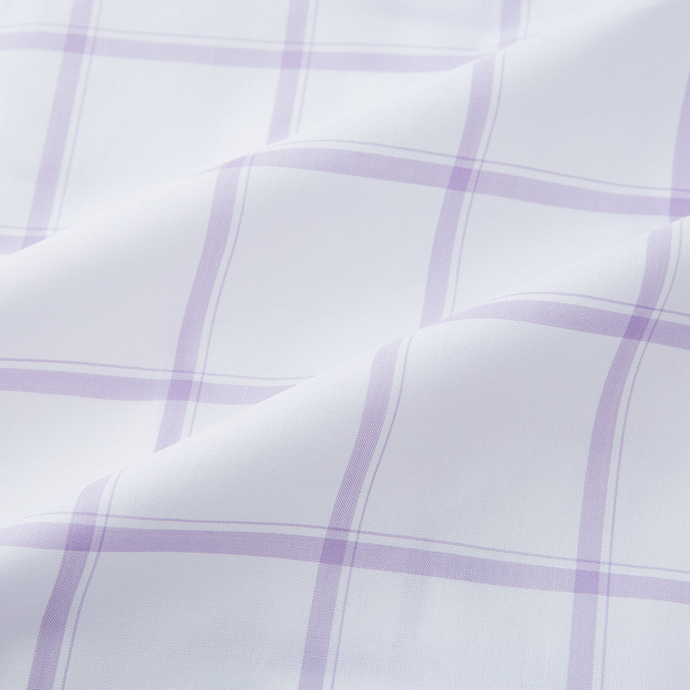 The Turnbull & Asser Lilac Grid Check Mayfair Shirt is a long-sleeve, button-up style crafted from Italian cotton with a white base and lilac grid check pattern, shown on a plain white background.