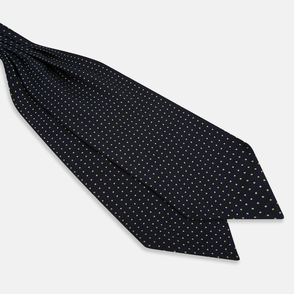 The Green Micro Dot and Navy Silk Cravat by Turnbull & Asser features fine green micro dots on navy silk, adding a refined touch to formalwear. Pair it with a matching pocket square for a cohesive, polished look.