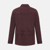 View 3 of product The Burgundy Kingston Corduroy Caban Jacket by Turnbull & Asser features black buttons, a notched collar, and front pockets. Crafted from premium cotton, it is shown on a plain white background.