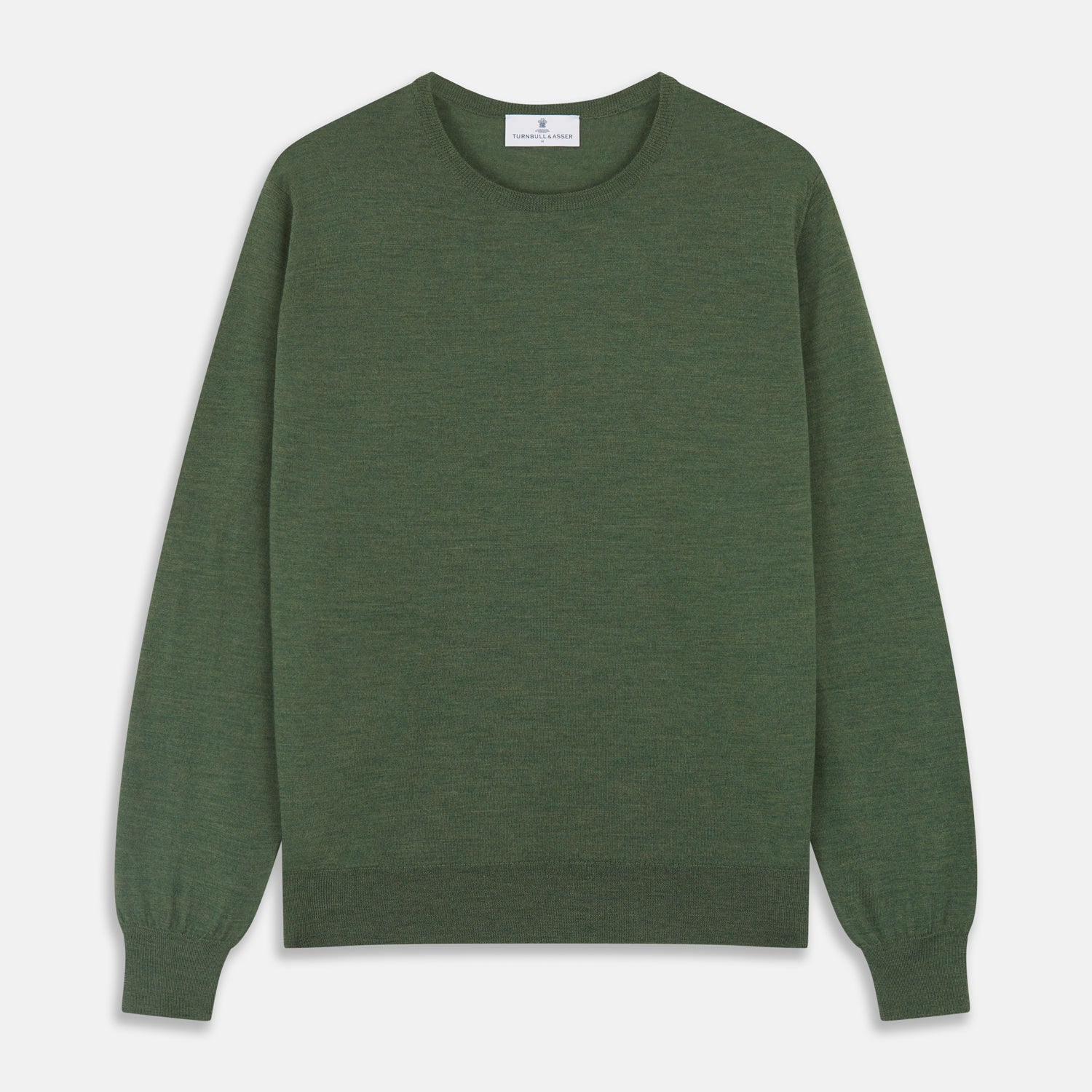 View 2 of product A man stands facing the camera against a plain light background, wearing the Turnbull & Asser Bottle Green Merino Kingston Crew Neck Jumper with dark pants and black shoes. His arms rest at his sides and he has a neutral expression.