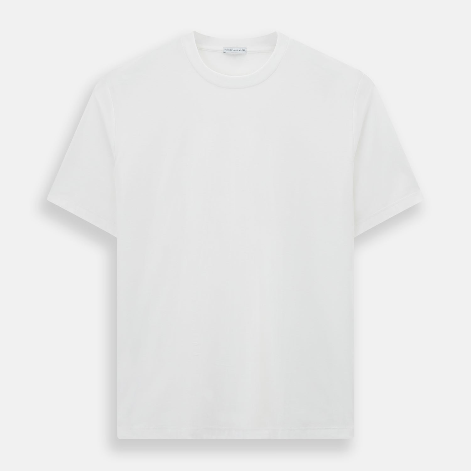 View 1 of product Experience comfort in the Turnbull & Asser White Short-sleeve Pyjama Shirt—a plain crew neck T-shirt laid flat on a white background, perfect as elevated loungewear or a sleek pyjama essential.