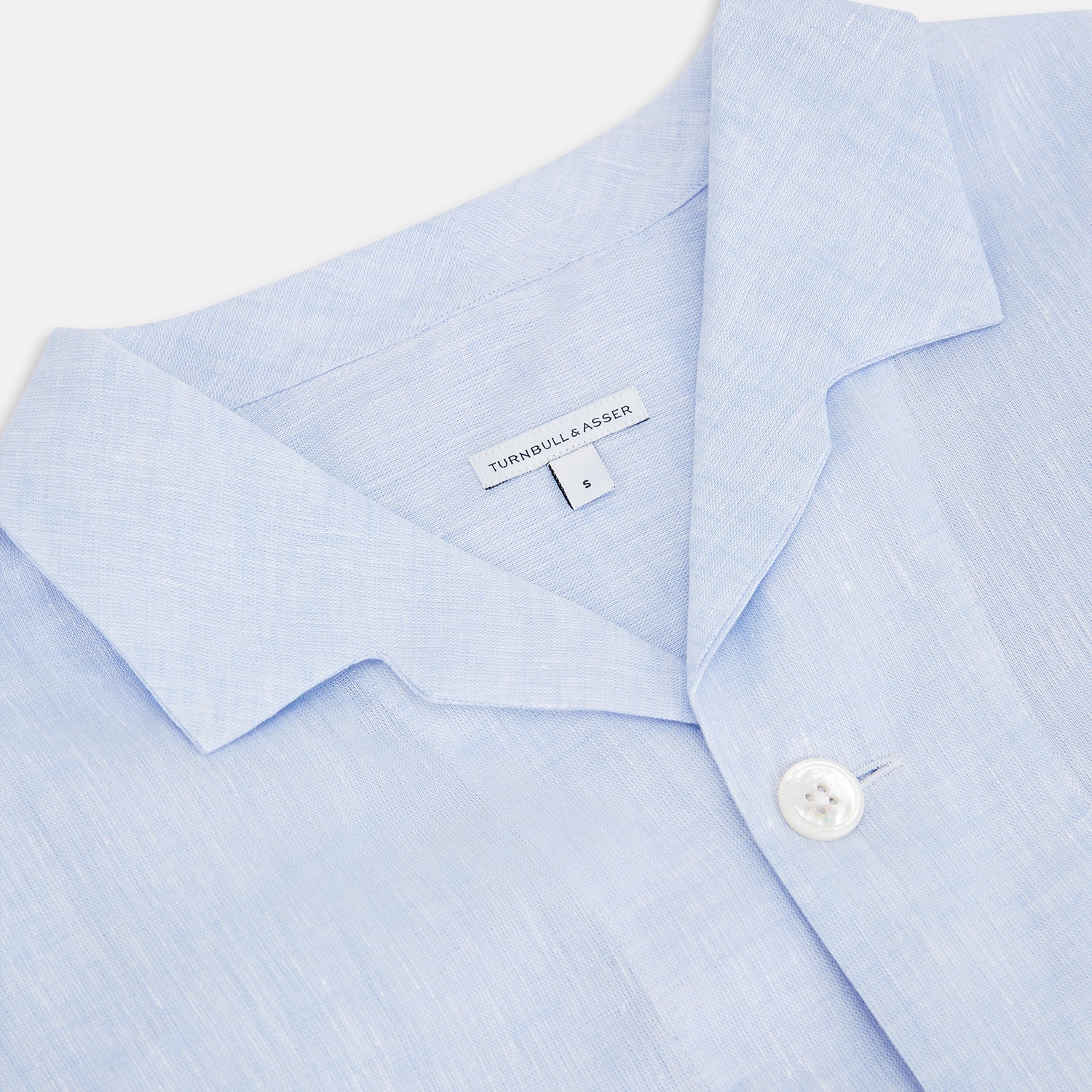 View 2 of product The Turnbull & Asser Pale Blue Linen Pyjama Shirt features long sleeves, a collar, front buttons, and a chest pocket—perfect as elegant loungewear or nightwear.