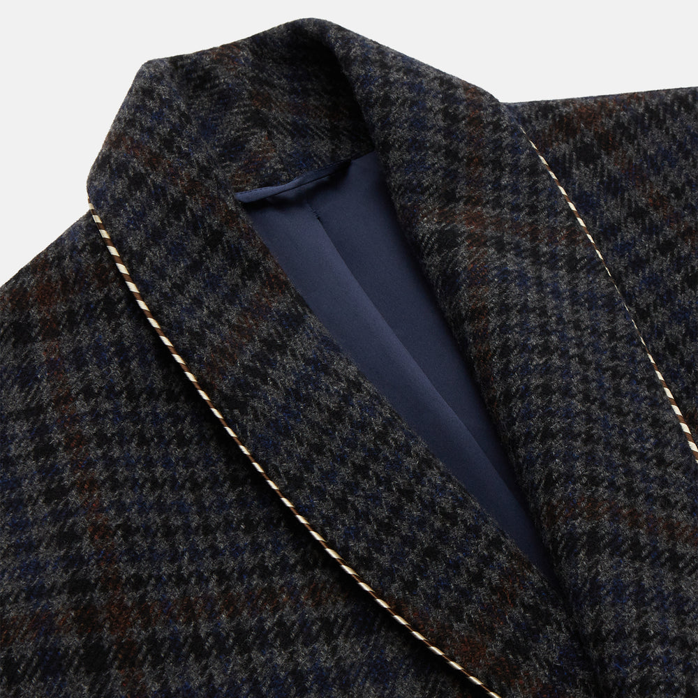 The Turnbull & Asser Charcoal Grey Check Wool Pierce Gown features a long, gown-style silhouette with a shawl collar, wrap-around belt, cuffed sleeves, and white edge stitching, shown against a plain white background.