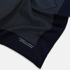 View 2 of product The Navy and White Stripe Silk Pocket Square by Turnbull & Asser features thin white vertical stripes and "TURNBULL & ASSER HAND PRINTED IN ENGLAND" in one corner, with a folded edge showing the reverse of this elegant silk accessory.