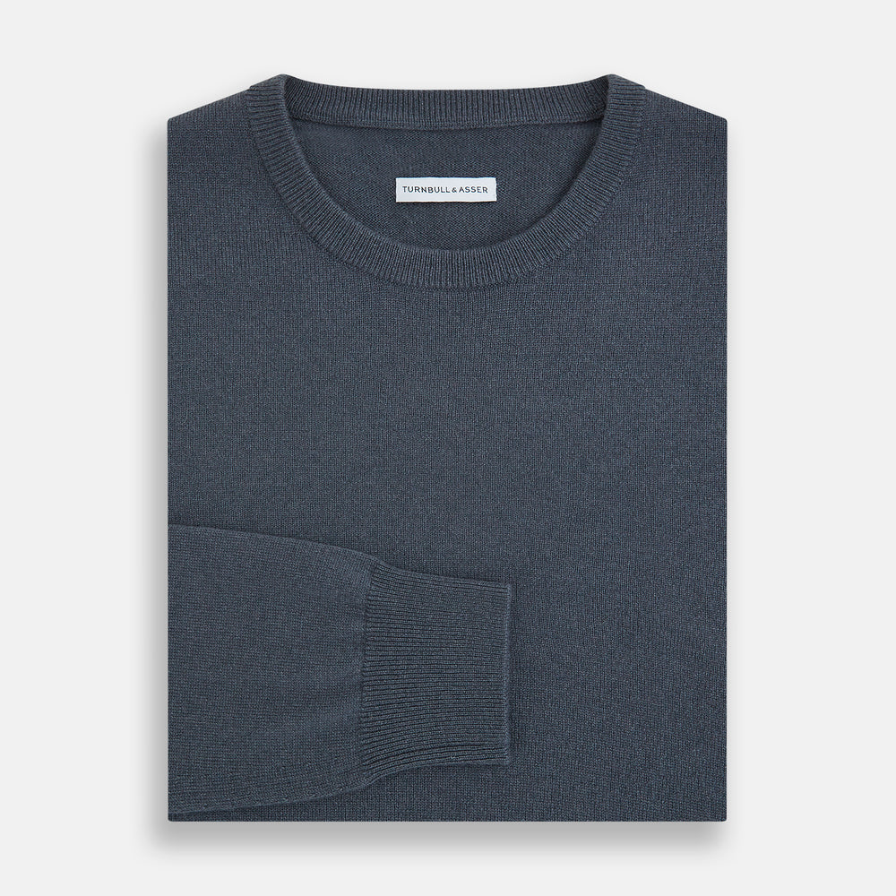The Turnbull & Asser Grey Cashmere Round Neck Jumper is shown against a light gray background, featuring a relaxed fit with ribbed cuffs, collar, and hem for an elegant look.
