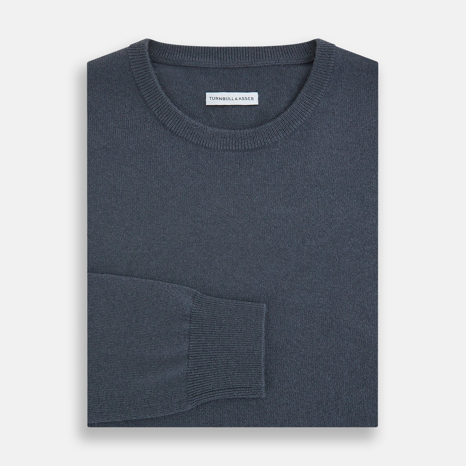View 4 of product The Turnbull & Asser Grey Cashmere Round Neck Jumper is shown against a light gray background, featuring a relaxed fit with ribbed cuffs, collar, and hem for an elegant look.