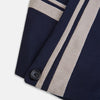 View 4 of product The Navy and Sand Stripe Neck Warmer by Turnbull & Asser features two beige diagonal stripes and a black button, draped in a V shape on a white background—an elegant formal accessory for any occasion.