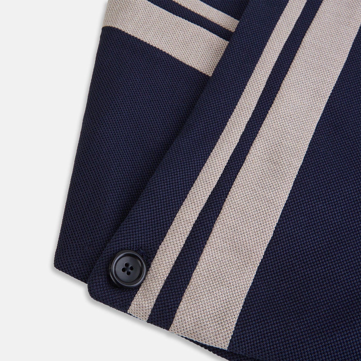 View 4 of product The Navy and Sand Stripe Neck Warmer by Turnbull & Asser features two beige diagonal stripes and a black button, draped in a V shape on a white background—an elegant formal accessory for any occasion.