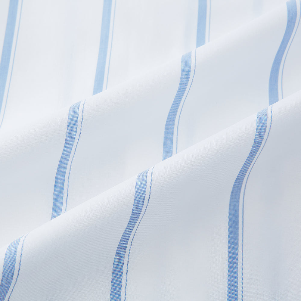 The Colony Blue Track Stripe Mayfair Shirt by Turnbull & Asser is a long-sleeve, button-up Italian cotton shirt with a white base and blue stripes, pointed collar, and buttoned cuffs, shown laid flat on a white background.