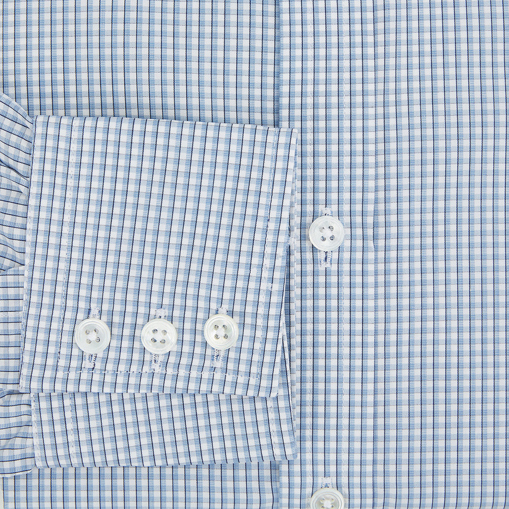 The Turnbull & Asser Blue Micro Shadow Check Mayfair Shirt features a long-sleeve, button-up design with a small blue and white check pattern, pointed T&A collar, and classic cuffs.