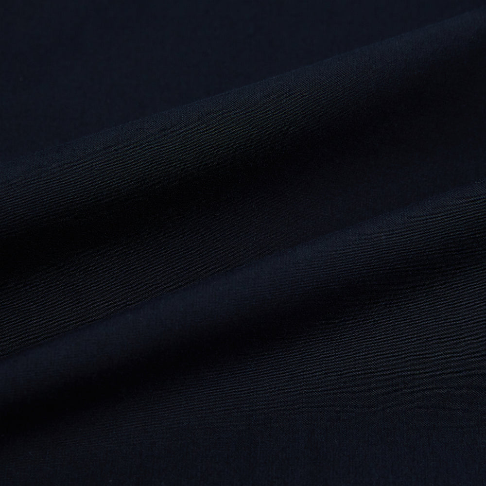 The NAVY BLUE WINDSOR SHIRT by Turnbull & Asser features long sleeves, a classic Windsor collar, white buttons, and buttoned cuffs—highlighting refined British craftsmanship against a plain white background.