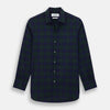 View 1 of product The Turnbull & Asser Black Watch Tartan Windsor Shirt is a long-sleeve, button-up shirt with a dark green and navy tartan pattern, white buttons, collar, and curved hem—showcasing British craftsmanship on a plain white background.