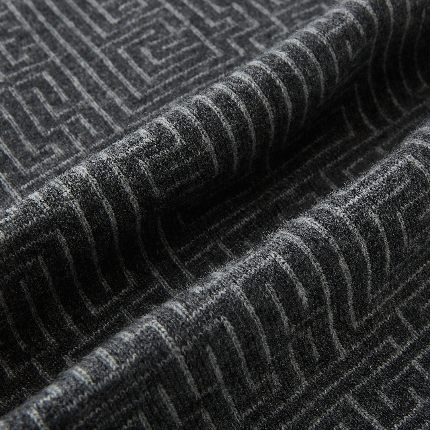 View 3 of product The Turnbull & Asser Grey Fretwork Cashmere Knitted Scarf showcases a geometric maze-like pattern in gray, elegantly looped with draped ends—an essential accessory set against a plain white background.