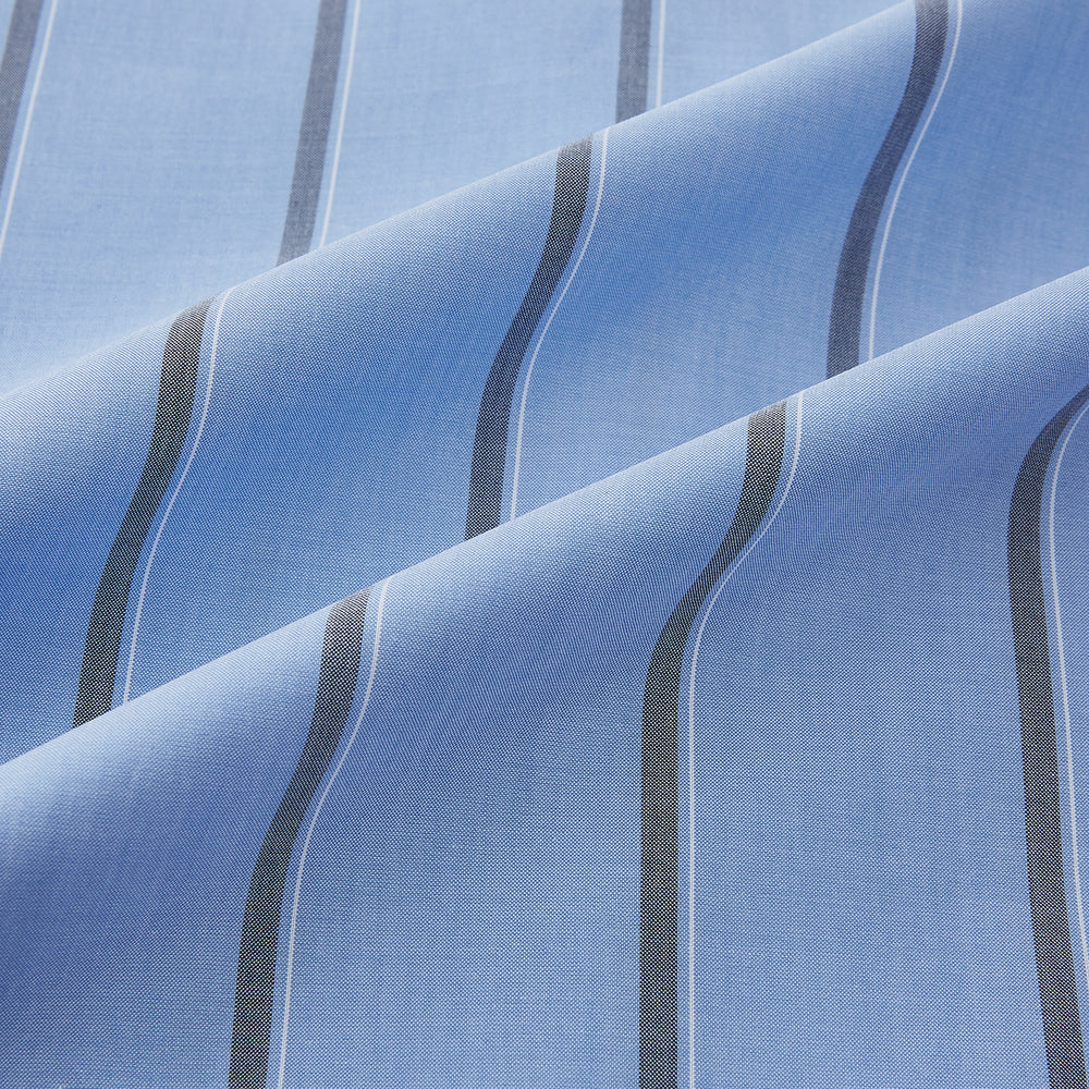 The Sky Blue Track Stripe Westminster Shirt by Turnbull & Asser features long sleeves, a Turnbull collar, and vertical dark blue and white stripes, displayed flat on a white surface.