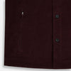 View 6 of product The Turnbull & Asser Burgundy Corduroy Hampstead Overshirt features long sleeves, a collar, a large left chest pocket, and two zippered side pockets, shown laid flat on a plain white background.