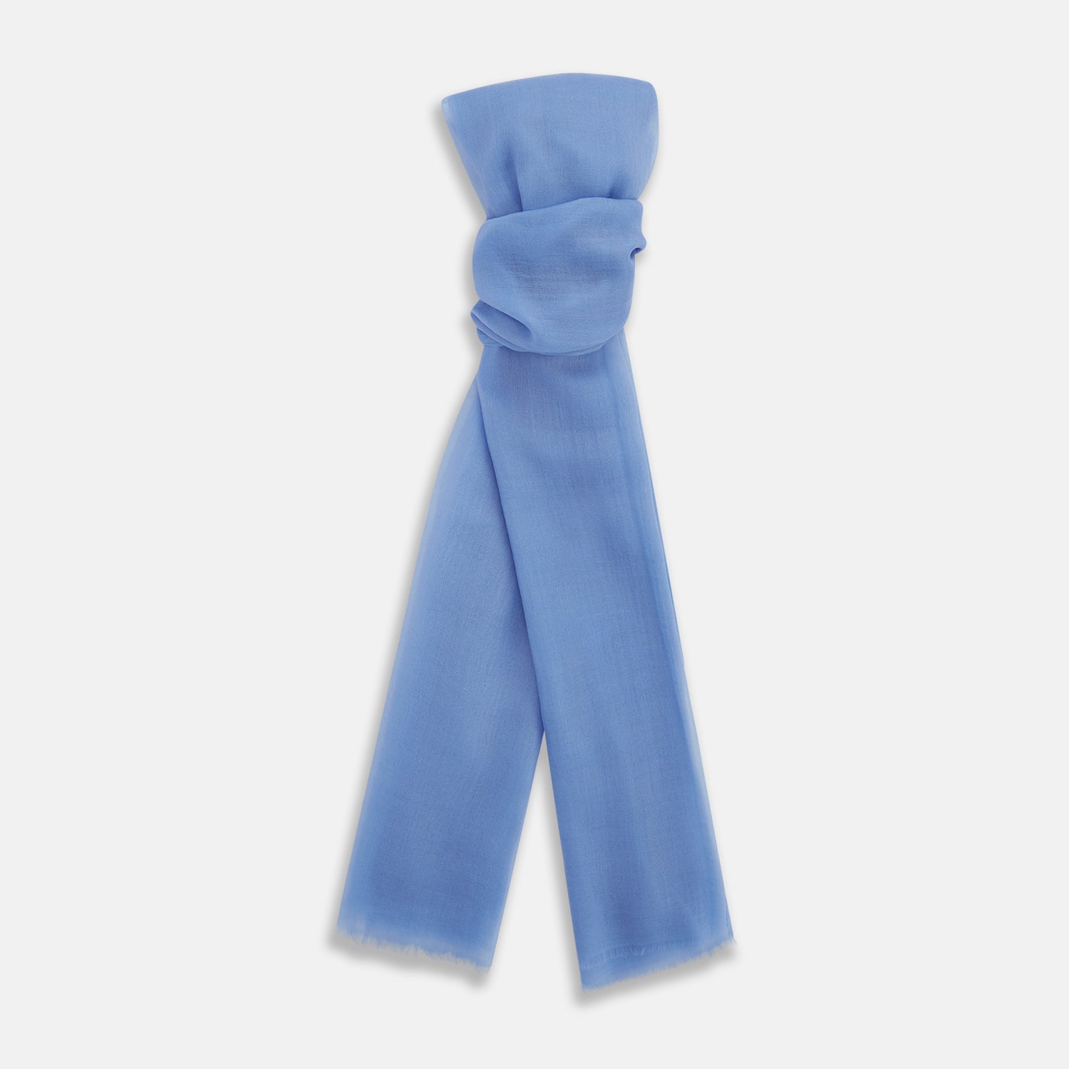 View 1 of product The Azzurro Cashmere Scarf by Turnbull & Asser is shown in light blue, hand-dyed cashmere, semi-sheer and loosely knotted, displayed against a plain white background.