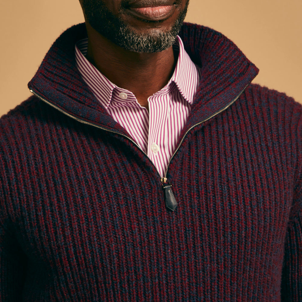 The Turnbull & Asser Burgundy Mullion Half Zip Rib Cashmere Jumper features a high collar and half-zip front in dark red and navy cashmere, shown laid flat on a white background—ideal for an elevated casual look.