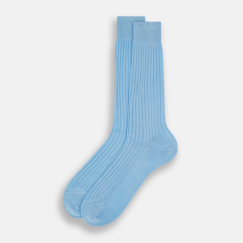 A single Turnbull & Asser Pale Blue Mid-Length Sock, made from Egyptian cotton with a ribbed texture, is displayed upright against a plain white background.
