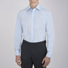 View 5 of product The Turnbull & Asser Light Blue Sea Island Quality Cotton Shirt features a T&A collar, double cuffs, white buttons, and a quality label inside the collar. Displayed on a plain white background.